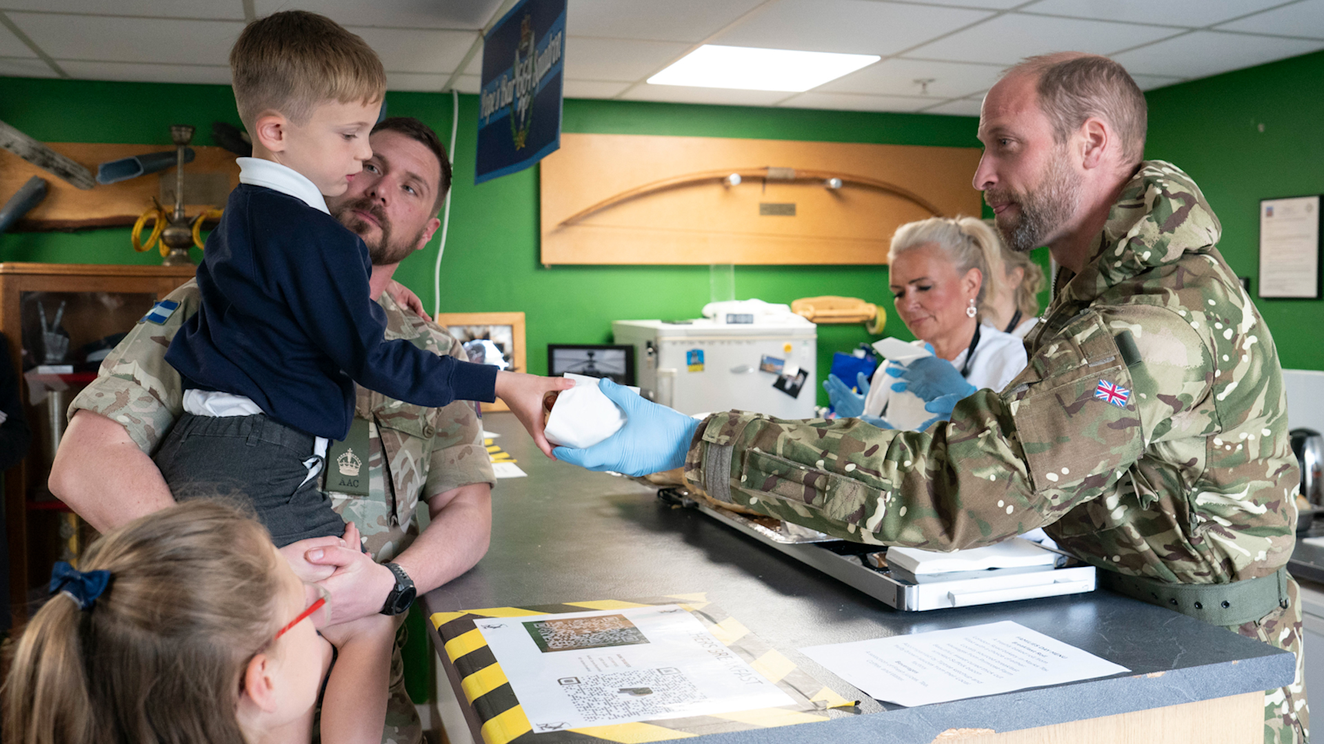 Prince William hands out breakfast rolls during visit to Army Air Corps
